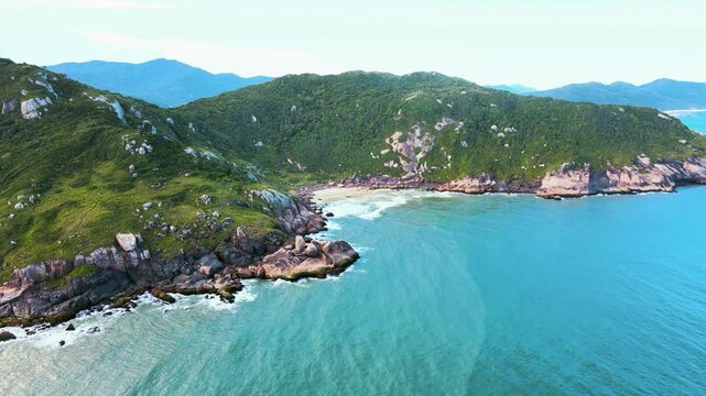 Aerial view of a deserted secret beach in Florianopolis, Santa Catarina, Brazil. A secret point in Lagoa da Concei&ccedil;&atilde;o between Gravata Beach and Praia Mole, a rocky coastline full of rocks