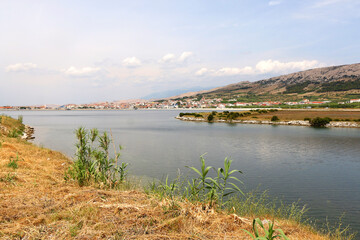 Traditional saltwork and skyline of town Pag, on island Pag, Croatia.