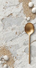 Gold spoon on textured marble with decorative golden and white pearls