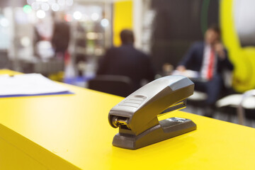 Black stapler on a table in showroom
