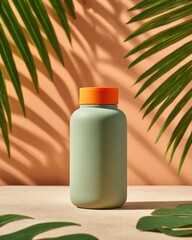 Olive bottle w/ orange lid casts palm shadows on peach backdrop, monstera leaves below