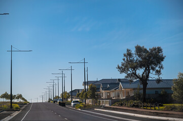 Landscape view of new road infrastructure and new houses in newly developed area, Eynesbury Township, Melton, Victoria, Australia	