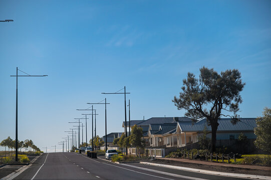 Landscape view of new road infrastructure and new houses in newly developed area, Eynesbury Township, Melton, Victoria, Australia	