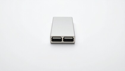 Fototapeta premium A sleek, metallic, rectangular device with two ports is featured against a simple white background.