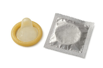 Condom unwrapped and still in its packaging on a transparent background