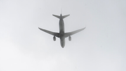 Large passenger plane in fog is gaining height. Take off aircraft into severe cloudy and fog.