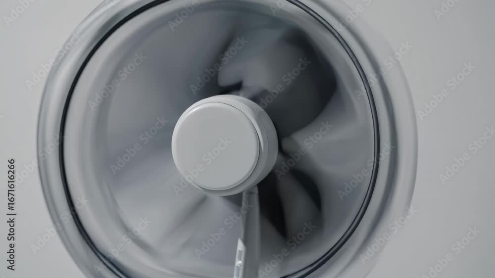 Poster close-up video of a spinning ceiling fan, captured from a low angle. the motion blur adds a dynamic 