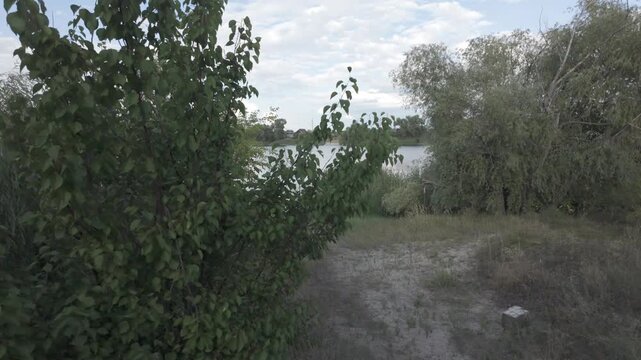 natural landscape on the water shore. lake shore. reflection of clouds in water. evening landscape with river. walk by the sea. water surface. Ukraine. 4k video with flat color profile. D-Log M.