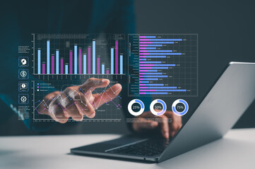 A person interacts with data visualizations on a laptop, displaying graphs and statistics,...