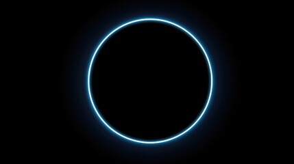 Fototapeta premium Glowing blue circle outline in a stark black background. Simple geometric shape with bright, diffused light effect against darkness