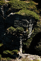 Close-up of massive rocky cliff with green vegetation on Stara Planina mountain. Serbia country