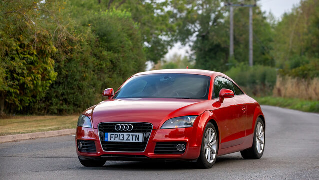 Whittlebury,Norhants,UK - Aug 23rd 2025:  2013 red Audi tt car driving on a British road