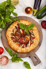 Ratatouille galette tart pie with eggplant, zucchini and tomatoes. Seasonal vegetarian dish. Top...