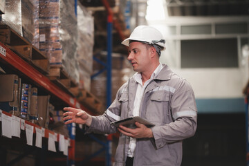 Distribution warehouse engineer check bar code examining inventory in stock. Merchandise...