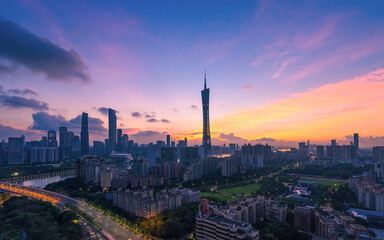 Guangzhou China architecture shows Pearl River New Town during a vibrant sunset.