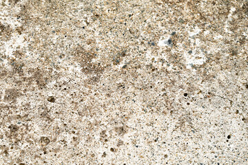 Dirty grunge rough concrete floor with gravel stones texture background. Stains on surface.