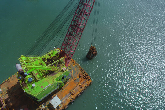 Floating Marine Crane Lifting Sediment from Sea Floor