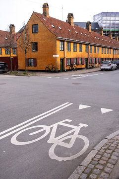 Bike lane and ochre houses in Nyboder Copenhagen Denmark, symbolizing cycling culture, urban sustainability, historic architecture and harmonious city lifestyle