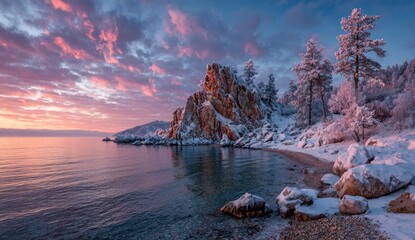 Winter sunrise over a snowy lake shore with dramatic rock formations