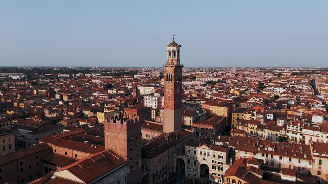 Aerial Drone Slow Pan Over Torre Dei Lamberti And Piazza Delle Erbe In Verona, Italy At Sunrise.
