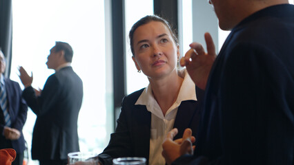 Smiling bartender serving drinks to customers at a modern bar
