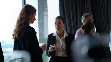 Business professionals networking and enjoying drinks at a corporate event