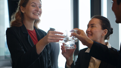 Smiling bartender serving drinks to customers at a modern bar
