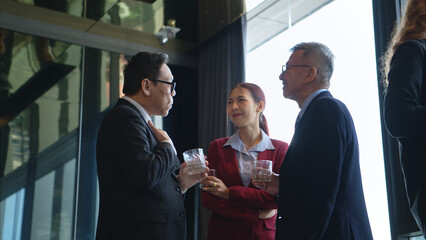Business professionals networking and enjoying drinks at a corporate event