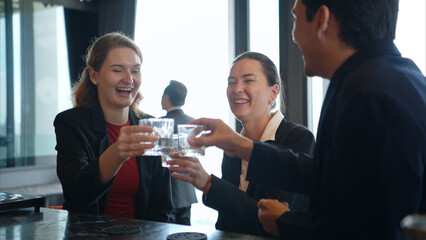 Smiling bartender serving drinks to customers at a modern bar