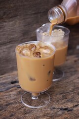 Pouring coffee with ice on glass