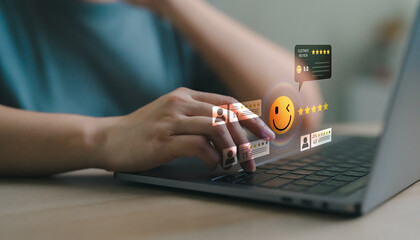 Hand using laptop with floating smiley emoji and star ratings, customer satisfaction, feedback score and online review dashboard in digital platform. Customer feedback dashboard rating system.