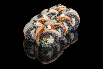 Black sushi rolls with fish, cucumber, and caviar on black background