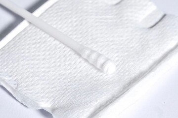 Close up clean cotton pad and cotton bud isolated on horizontal white background.