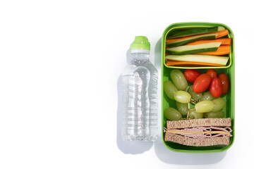 Healthy Lunchbox for school with sandwich,fruit and vegetables isolated on white background. Top view. Copy space	