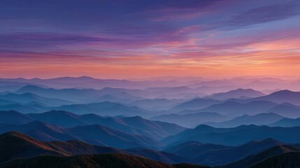 Fototapeta premium Serene mountain landscape at sunset with layered peaks and colorful sky, ideal for nature enthusiasts
