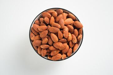 Almonds in white bowl on white background. Perfect for recipes, articles or any cooking content