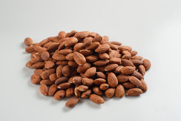 Heap of almonds isolated on white background. Perfect for recipes, articles or any cooking content