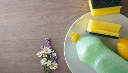 Background with organic product for hand washing dishes on wooden