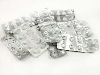 Used pill pack blisters are on a white table, top view. Treatment and medication concept
