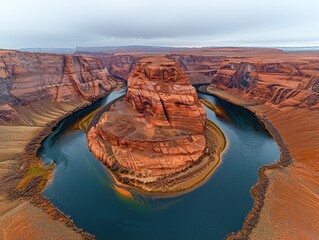 Grand Canyon, Horseshoe Bend. Vast, sweeping vista of the Colorado River's horseshoe bend, framed by rugged red rock formations. Cloudy sky, calm water, and vibrant colors