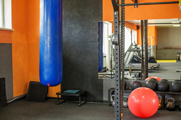 Boxing bag and fitness equipment in gym corner