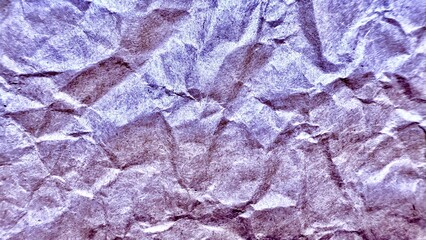 crumpled metallic lavender paper texture with shimmering folds for abstract background or creative design surface