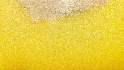 shimmering golden yellow glitter surface with radiant sparkling highlights ideal for festive...