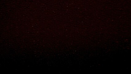 deep maroon granular texture with subtle shimmer effect ideal for abstract background or dark atmospheric design element
