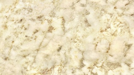 luxurious creamy quartz stone surface with golden mineral veins ideal for elegant background or natural texture design