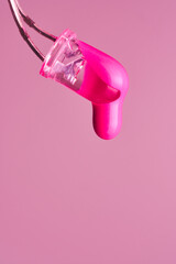 Magenta paint drop falling from led