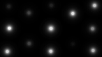 Scattered White Bokeh Lights On A Black Background glowing blurred