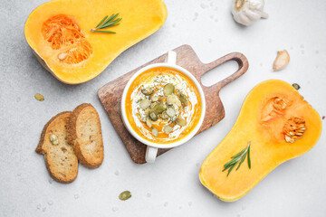 Butternut squash soup with pumpkin seeds and herbs served with crusty bread and garlic.