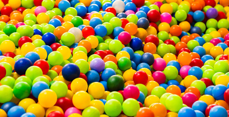 A sea of colorful plastic balls fills a childrens play area inviting kids to jump in and enjoy the vibrant atmosphere Sunlight enhances the playful setting creating joy