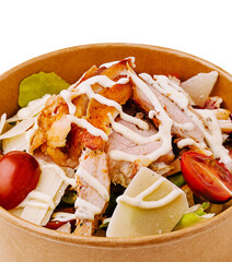 Fresh chicken salad with cherry tomatoes and creamy dressing served in a bowl